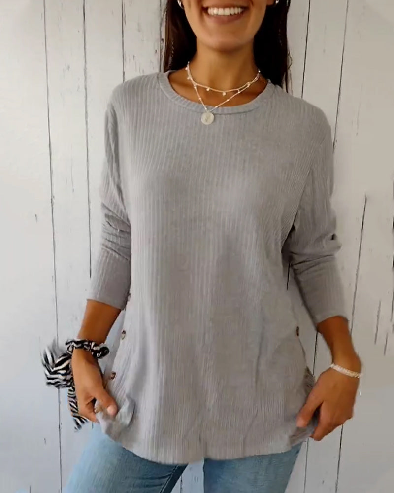 Elegant, strikket top med lange ærmer og rund hals