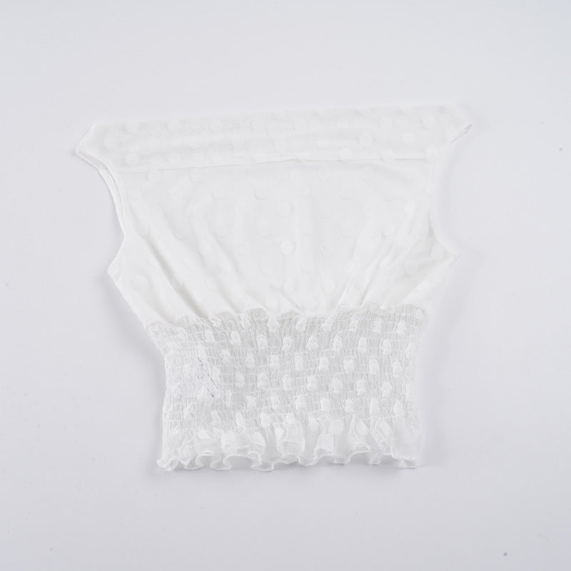 Asymmetrisk topp med volangdetaljer och transparenta inslag