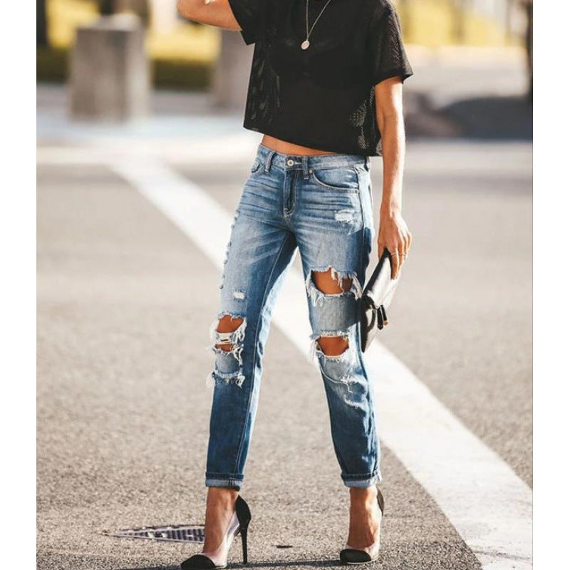 Moderne Slim-Fit Jeans med Trendy Slid og Frayed Detaljer