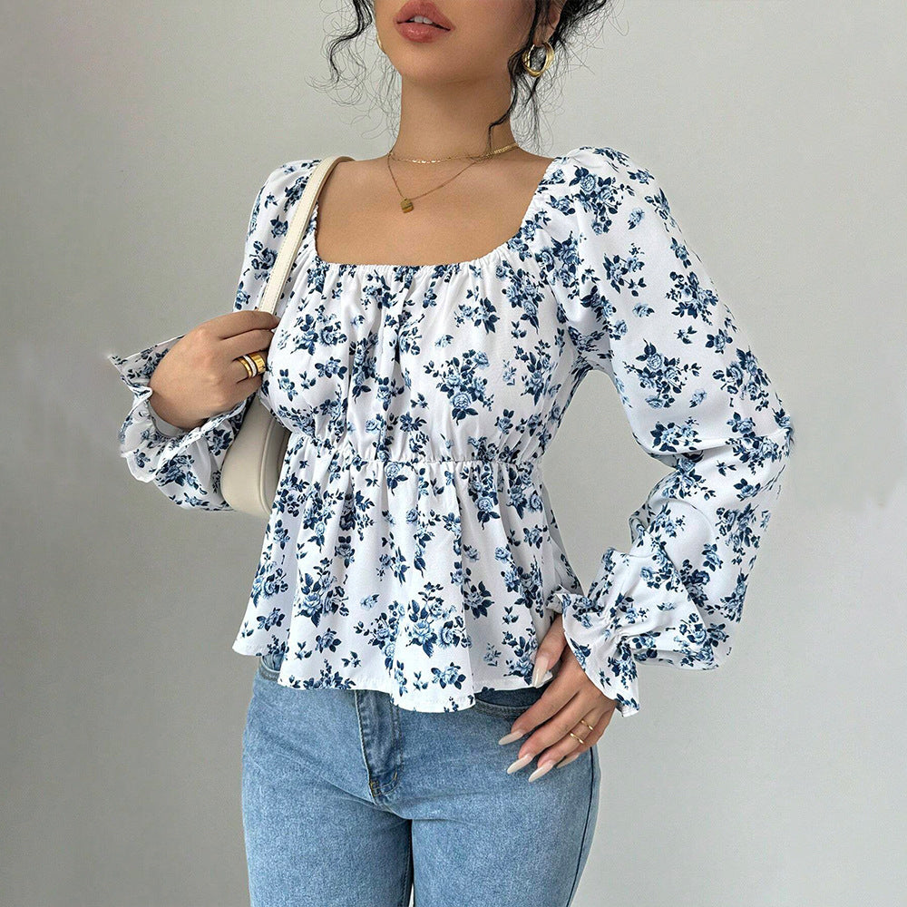 Stilfull blus med blomstertryck och puffärm