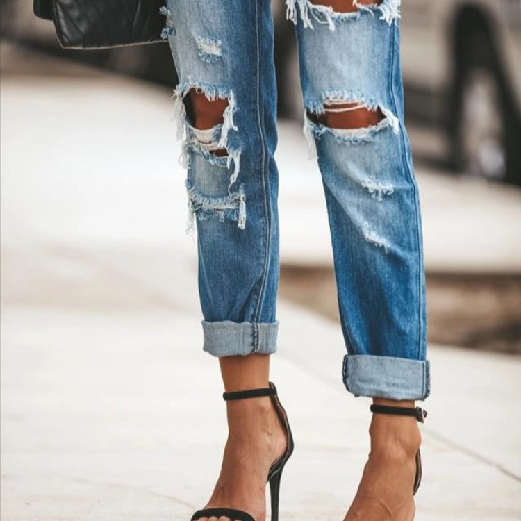 Moderne Slim-Fit Jeans med Trendy Slid og Frayed Detaljer