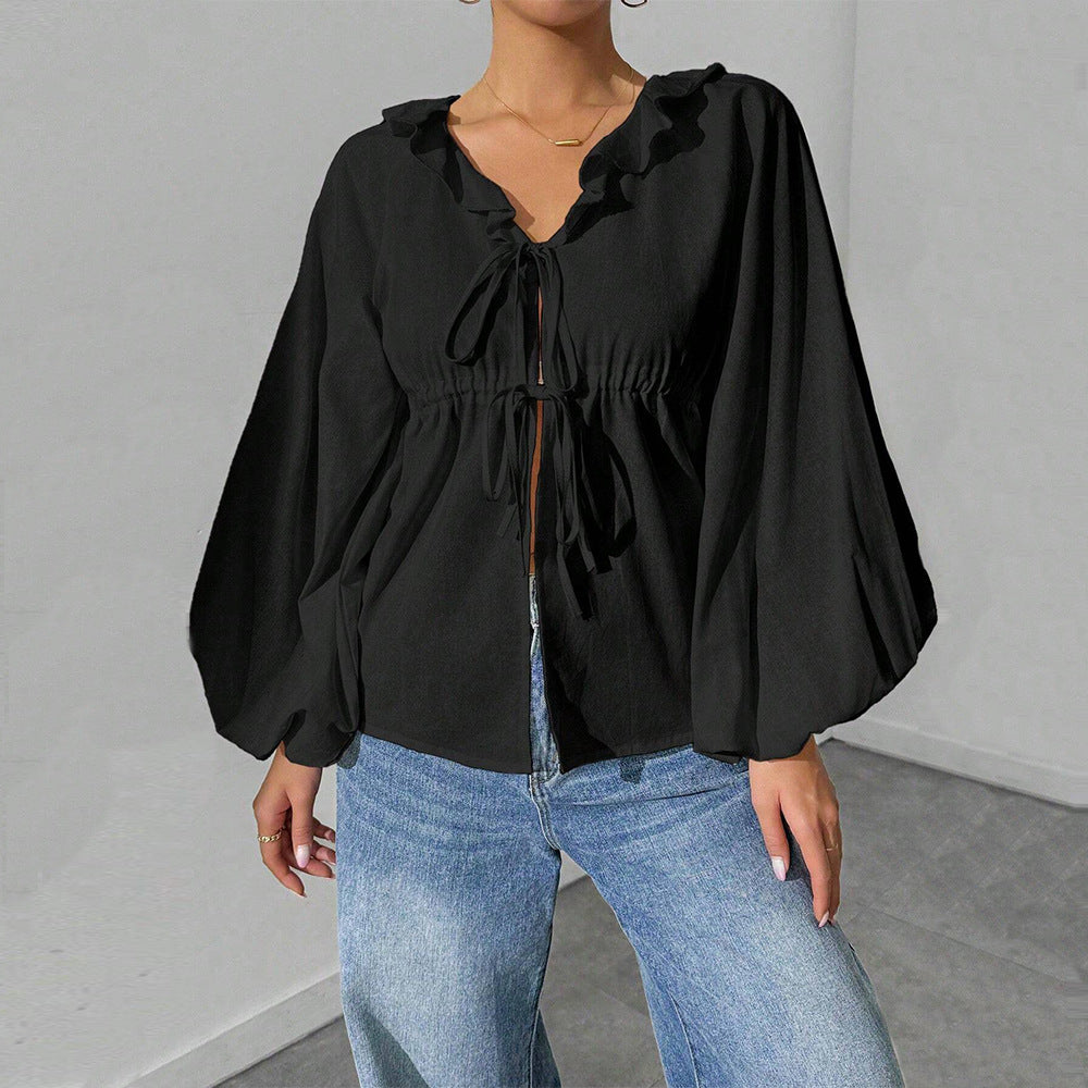 Elegant skjortjacka med voluminösa ärmar och feminina detaljer
