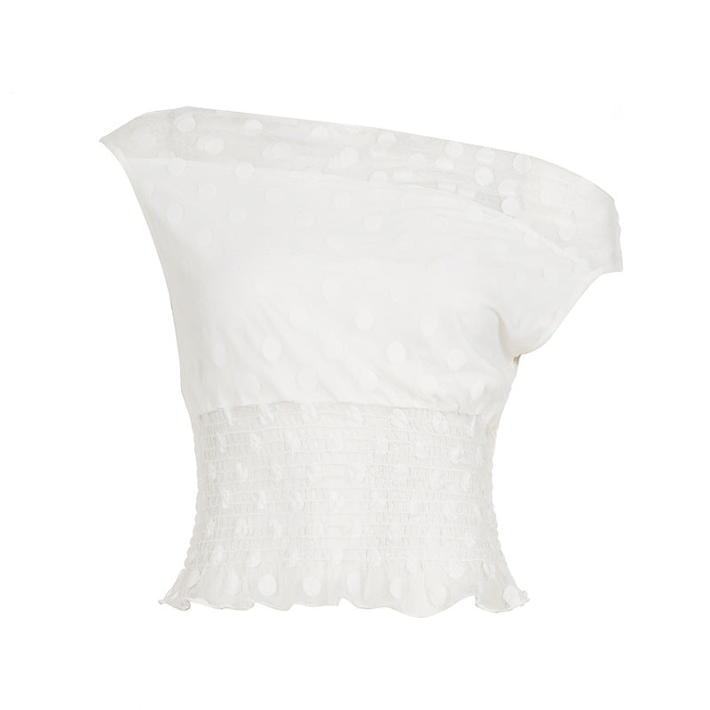 Asymmetrisk topp med volangdetaljer och transparenta inslag