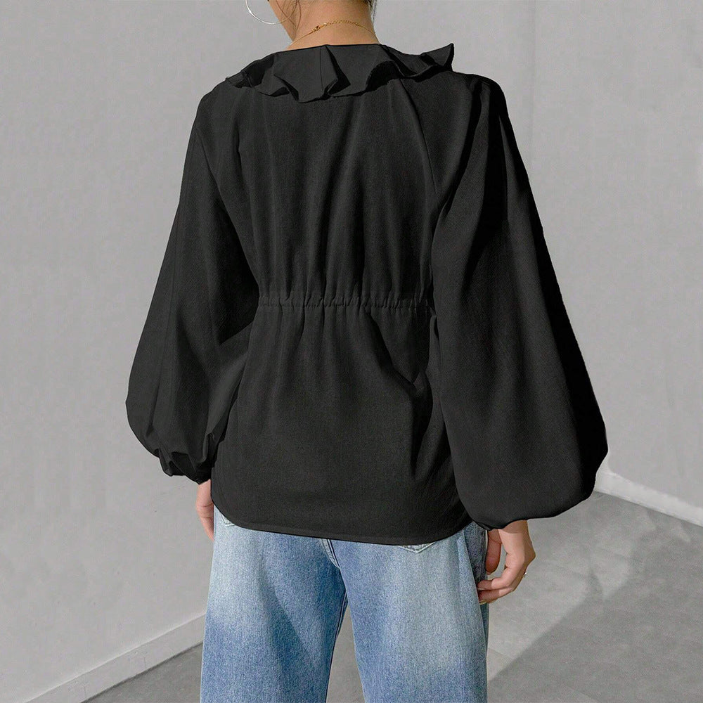 Elegant skjortjacka med voluminösa ärmar och feminina detaljer